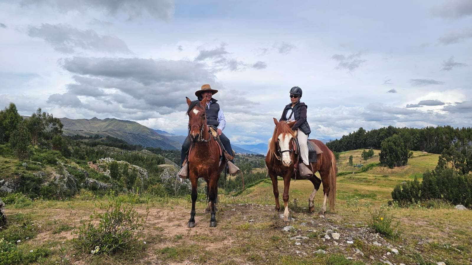 Horseback riders with panoramic Cusco mountain view