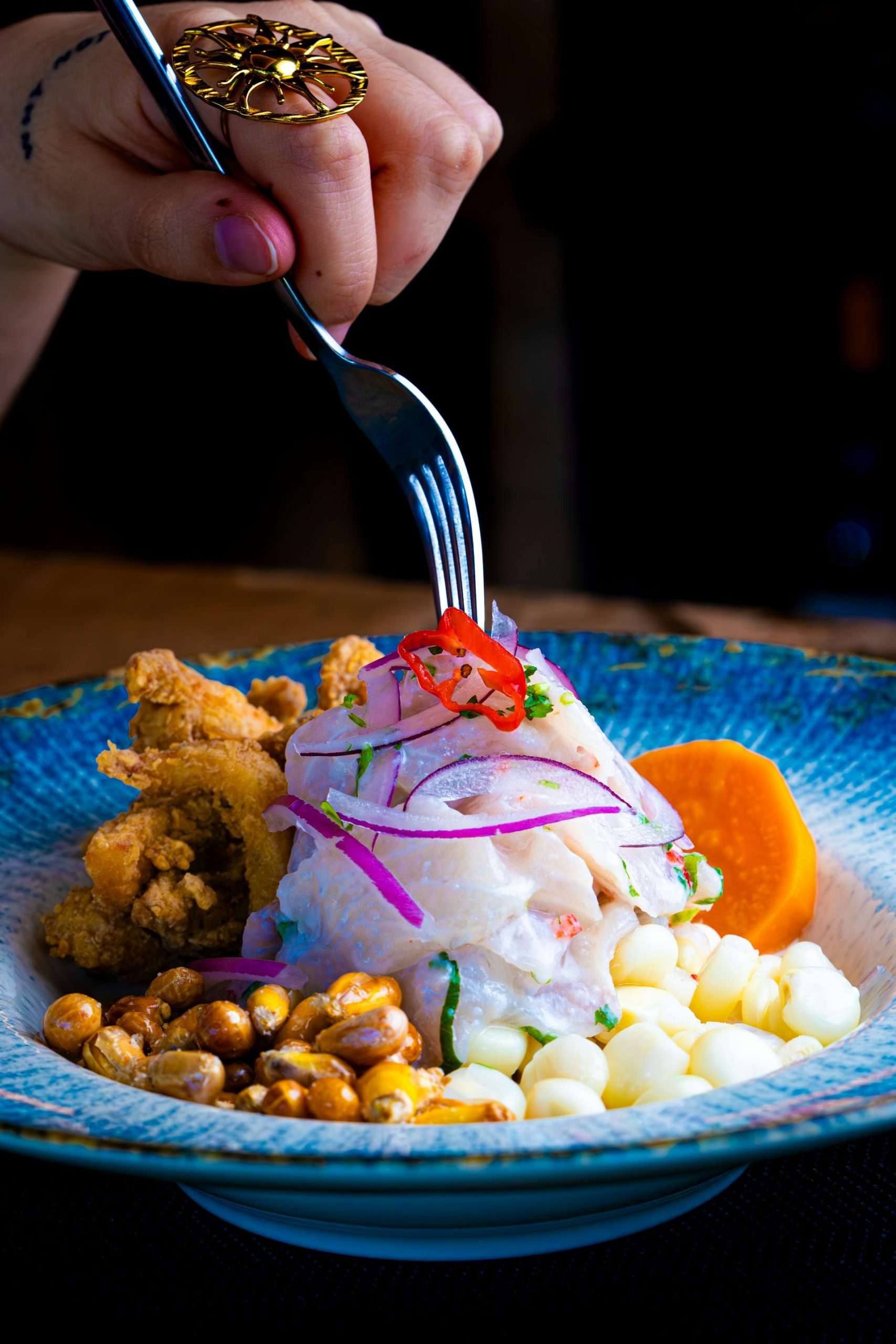 Gourmet Peruvian ceviche with fresh seafood, corn, and citrus garnish