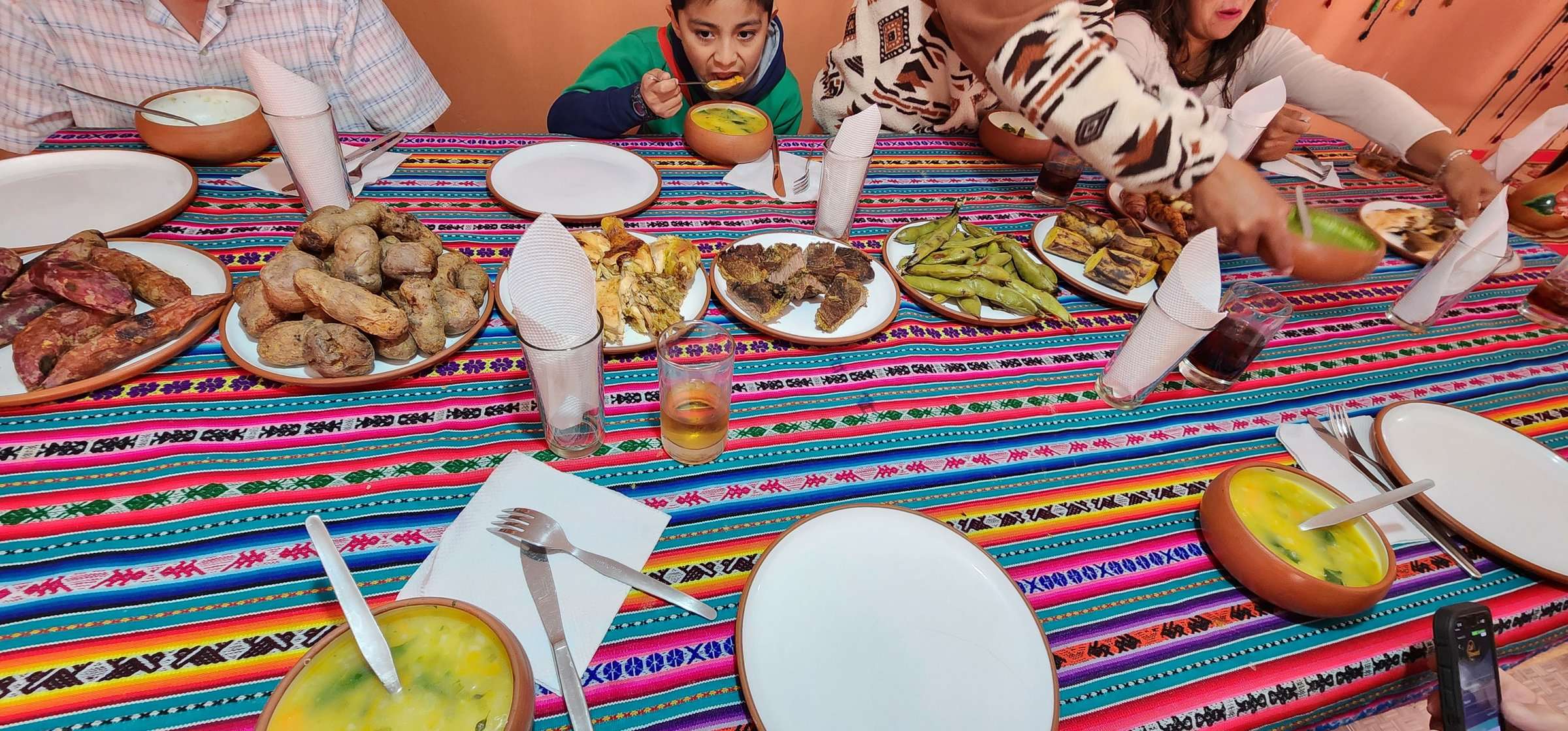 Traditional pachamanca feast spread with roasted meats potatoes and corn
