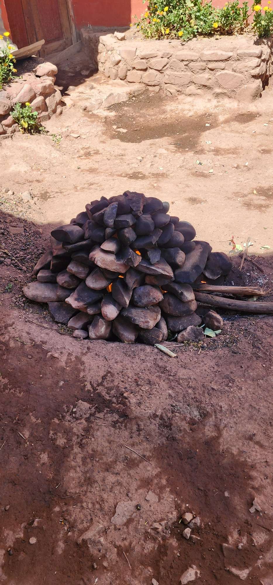 Fire-heated stones piled to build a traditional pachamanca earth oven