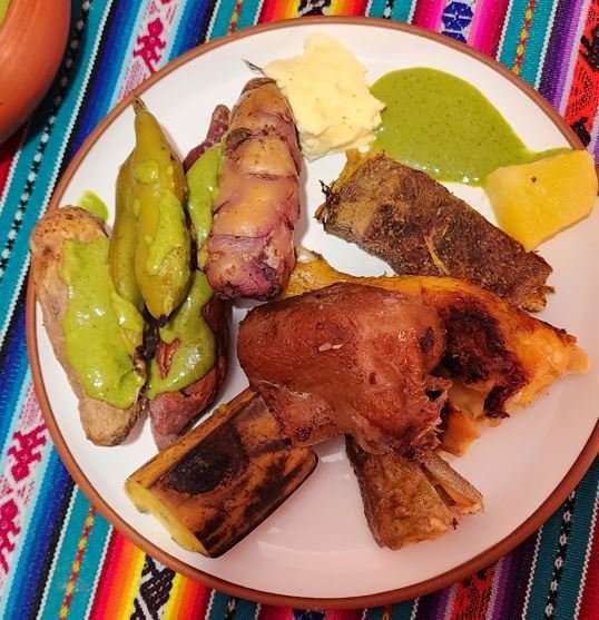 A pachamanca plate of slow-roasted meats, native potatoes and Andean peppers fresh from the earth oven